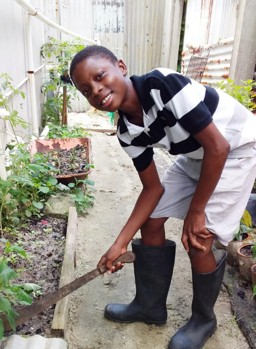 Albouystown teen trades bat and ball for Shovel and fork