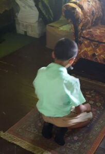 Teacher building furniture and creating prayer space for his students 