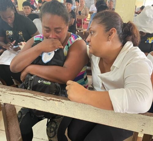 Minister of Education, Priya Manickchand, second left interacts with children of the Mahdia Secondary School who were affected by the fire on Sunday night. Prime Minister, Brigadier (Ret’d)Mark Phillips , fourth left, and Minister of Home Affairs, Robeson Benn were also on the scene.(MoE photo)